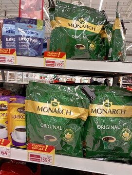 Huge selection of coffee from various Russian and international brands on shelves of Auchan grocery supermarket. Prices in rubles are displayed under packages. Krasnodar, Russia - October 1, 2025