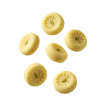 Five Levitating Cubes of Yellow Indian Sweet Peda Garnished with Saffron and Pistachio isolated on a transparent background 