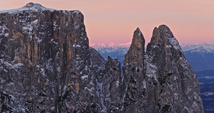 Panoramic view of Dolomite mountain peaks in beautiful morning light. Early winter scene with snow covered summits.