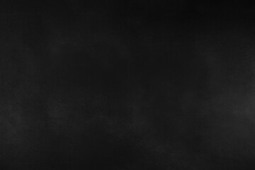 Dark textured black background with subtle rough surface details captured in clean flat lay top...