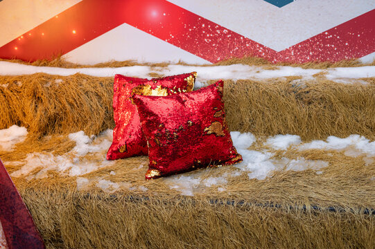 Festive red sequin pillows on straw with snowflakes and holiday decor - Powered by Adobe