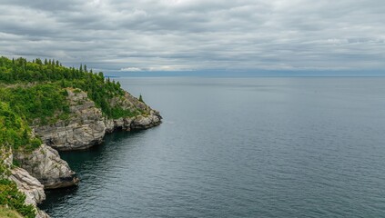 Landscape of a granite quarry beneath a cloudy summer sky, emphasizing geological extraction practices