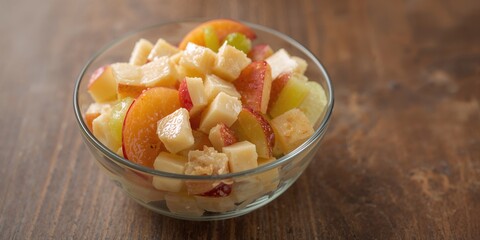 Fresh fruit salad with vibrant colors used as a colorful background for layout design, ideal for summer menus