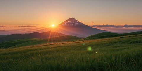 Mountain grassland at sunset with sunbeams, emphasizing natural landscape for background use