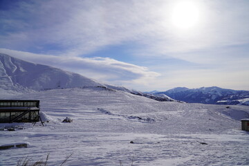 A snow-covered mountain range in the Caucasus region near the Gudauri ski resort. Georgia. Snow-capped mountain peaks and steep slopes.