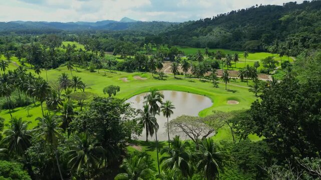 A still aerial capturing the landscaped grounds of Canlubang Golf and Country Club, highlighting large puddles of water surrounded by lush greenery and tropical trees in Calamba Laguna, Philippines