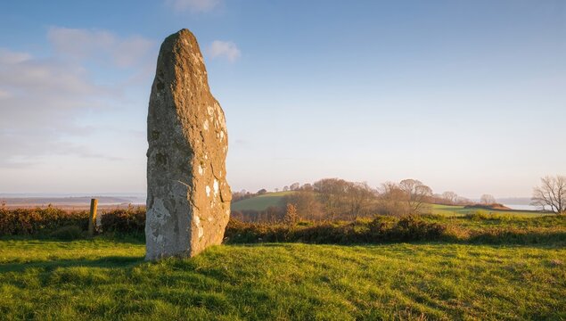 Ancient megalith in a rural setting, erosion risk