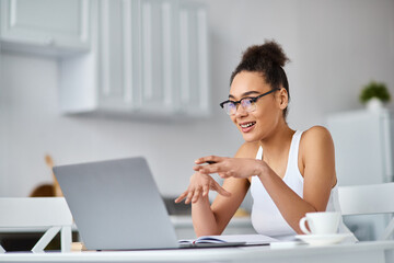 Young beautiful woman enjoying a cozy day at home while working on her laptop