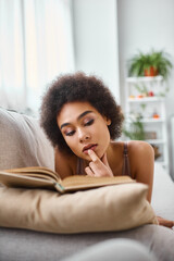 Cozy afternoon with a book at home for a young beautiful woman