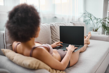 Enjoying a cozy afternoon at home while working on a laptop in comfortable attire