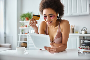 Joyful moments of a young woman enjoying her cozy home while shopping online