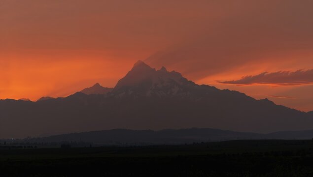 Vibrant sunset over Rocky Mountains viewed from Broomfield during wildfire season, landscape preservation awareness