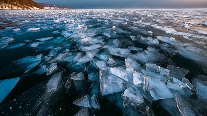 Aerial view of cracked sea ice along a rugged shoreline showing melting patterns climate change concerns raw northern nature and dramatic environmental storytelling - Powered by Adobe