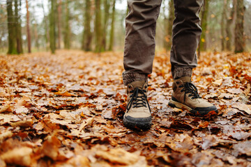 Low angle photo of a hiker in motion. Close up of hiking boots in motion on a hiking trail in the...