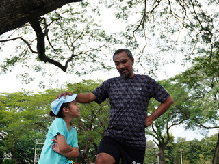 Father and Daughter Playing Soccer and Juggling Ball Outdoors