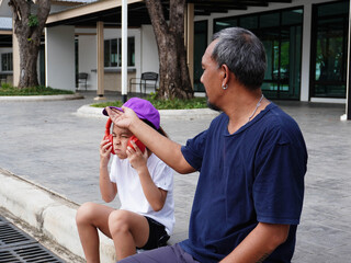 Father Comforting Daughter Resting with Headphones After Jogging