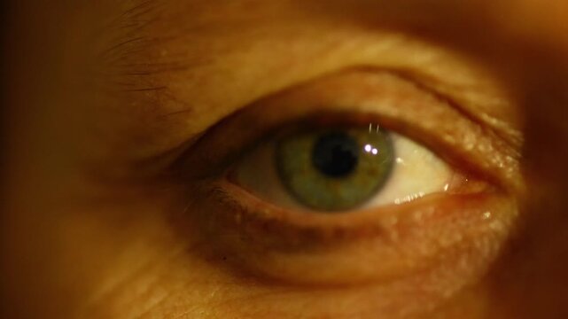 Close-up of green human eye shifting focus, blurring and refocusing to illustrate vision problems, eye strain and difficulty seeing clearly