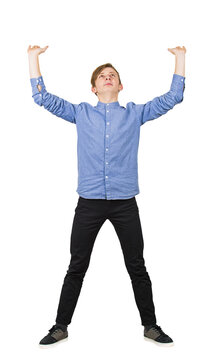 Young male stands strained with his arms raised, holding his palms up as supporting an invisible weight above head. Guy looking upward at the imaginary load with responsibility. Full body length
