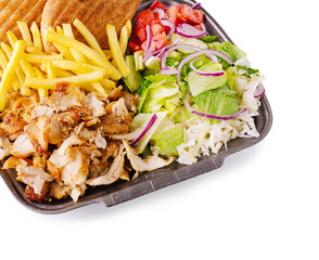 Delicious meal featuring chicken, fries, salad, and pita bread served together
