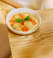 Creamy seafood dish served in a modern dining area with natural light