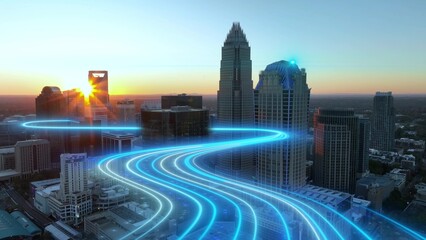 Aerial view of Charlotte city skyline at sunset with glowing network lines over roads illustrating future smart city connectivity and energy data streams