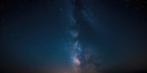 Astrophotography of a dark blue starry sky with many stars, nebulae and galaxies, serving as a cosmic background for visual layouts