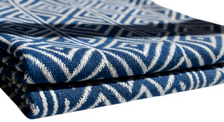 Close up of folded blue and white textile with geometric pattern isolated on transparent background