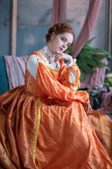A red-haired girl in a medieval outfit at a ball in a castle interior