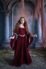 A girl in an elf costume in a studio with fabrics. Medieval decorations