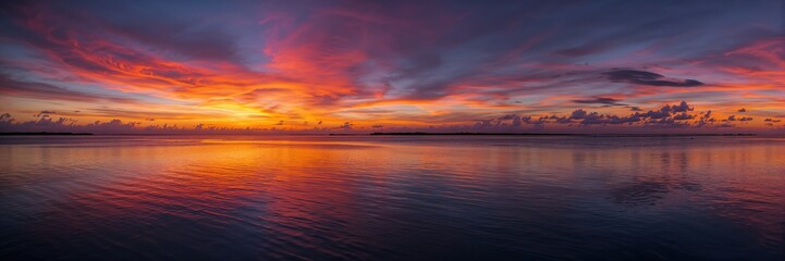 Obraz premium Sunset reflecting on a coastal lagoon with a dramatic sky, emphasizing natural scenery and evening light, Earth Day