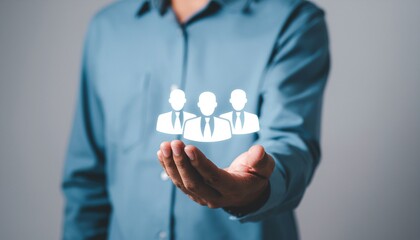 Hand Holding Teamwork: A person extends their hand, cradling a cluster of team member icons, symbolizing the concept of teamwork and collaboration.