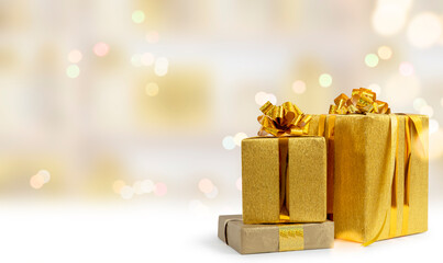 Golden gift boxes for holidays, birthday, promotions, christmas, new year, wedding. Elegant luxury wrappers, lush bows. Blurred background.