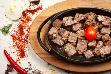 Meat casserole in a cast iron pan.  Turkish Kavurma.