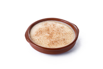 Spanish custard served in a bowl with cinnamon isolated on white background