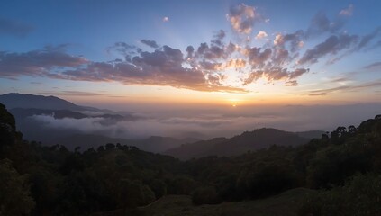 Obraz premium Dramatic sunset over misty mountains with vibrant clouds