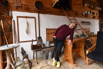 Woman standing in a rustic workshop setting