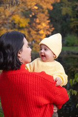 Portrait Mother and Baby Smiling in Autumn Park