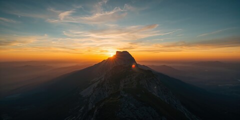 Sunrise over mountain ridge with hill Jested, emphasizing natural light on scenic landscape