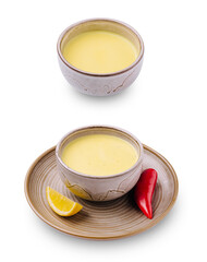 Delicious traditional soup in ceramic bowls with lemon and chili