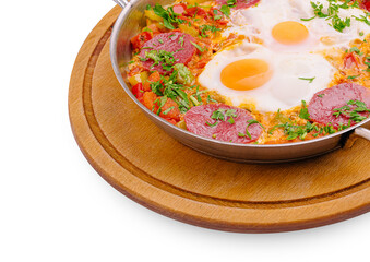 Delicious shakshuka served in a pan with fresh herbs and vegetables