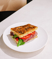 Delicious roast beef sandwich served on a white plate