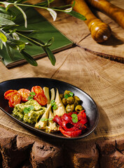 Colorful vegetable platter served on a wooden table in a rustic setting