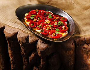 Delicious dish of roasted peppers served on a rustic wooden table