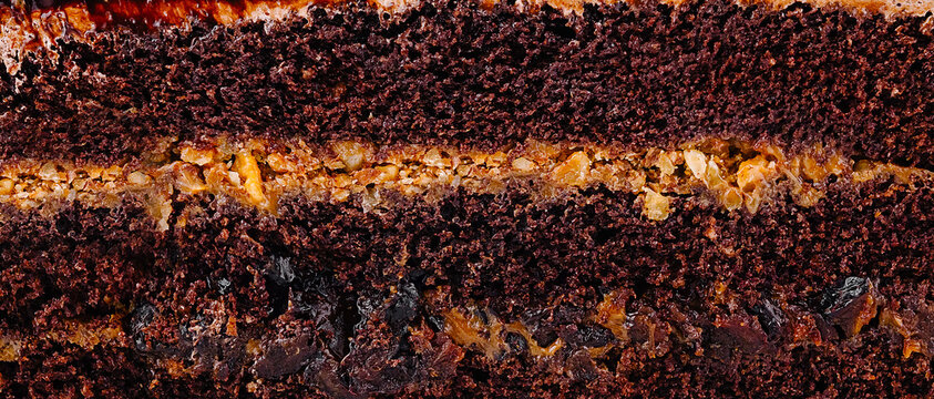 Rich chocolate cake layered with caramel and crunchy nuts ready to serve