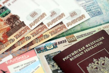 Fragment of Russian Federation visa in passport page and russian money close up. Concept of travel and tourism in Russia