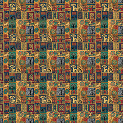 Obraz premium Seamless African tribal patchwork pattern featuring safari animals, baobab trees, and geometric motifs in earth tones, symbolizing savanna nature and folklore.