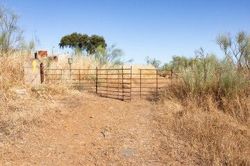 Camino Mozarabe de Santiago - way of Saint James - a fence with gate on a rural path between Hinojosa del Duque and Monterrubio de la Serena, Spain
