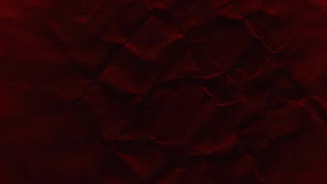 A textured red background with subtle crinkles and shadows, resembling artistic paper or fabric material.