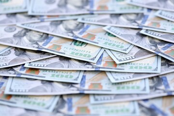 Many one hundred dollars money bills banknotes on smooth surface close up. Concept of business, rich life and economical questions in United States of America and around the world