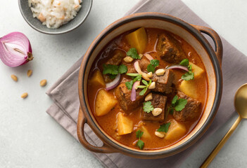 Delicious and hearty Massaman curry with beef, potatoes, onions, and peanuts, served with rice